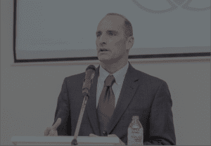 bruce speaking in ghana at podium