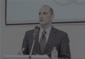 bruce speaking in ghana at podium