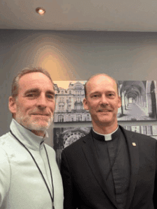 Bruce and a priest taking a selfie