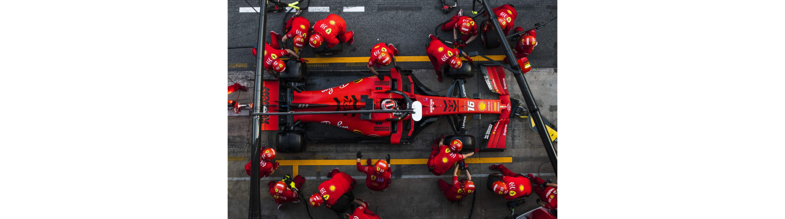 Pit stop image Formula one support team changing tires on a red racecar